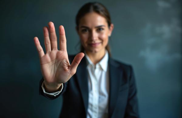 a well dressed woman kindly putting her hand up