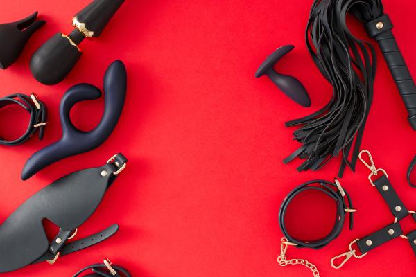 sex toys laid against a red background